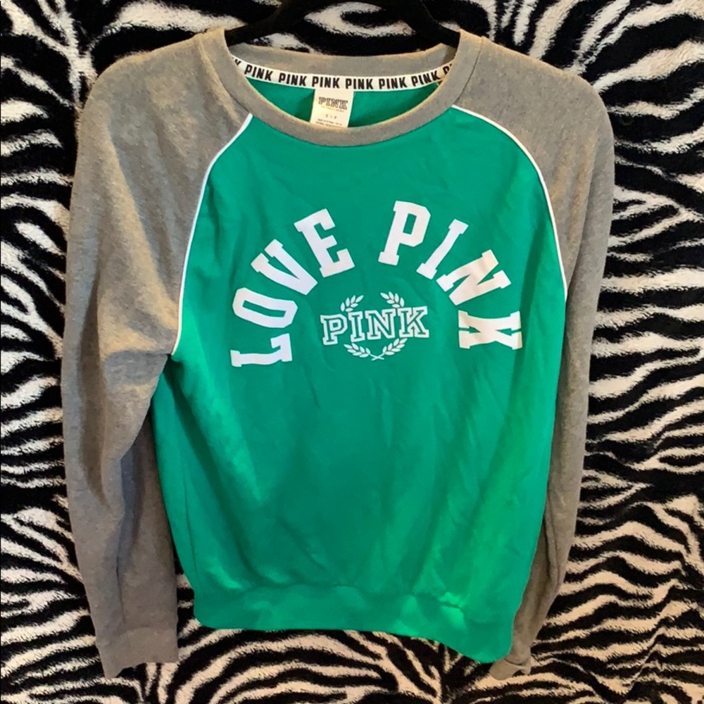 a green Pink crewneck sweatshirt